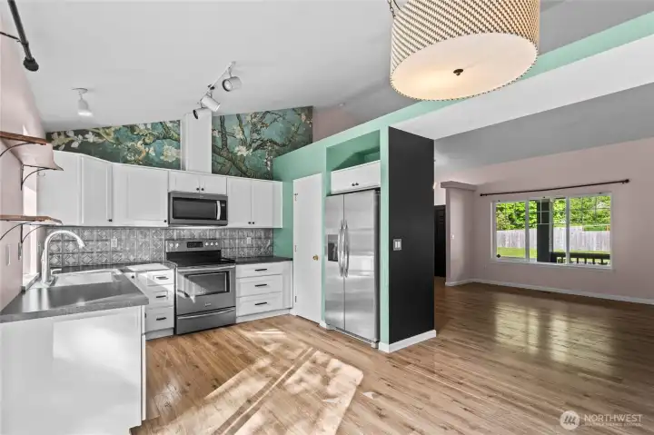 Another View that is from the rear slider looking into kitchen and out towards large Flex room.Cathedral Celings and tons of storage everywhere.