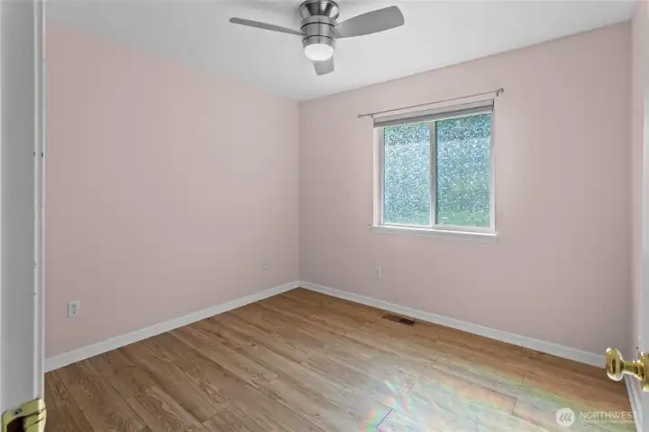Generous sized bedroom with remote operated ceiling fan