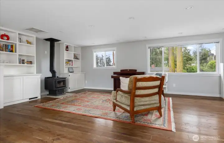 Expansive Living Room with built in storage and free standing wood stove. Expansive Living Room with built in storage and free standing wood stove.