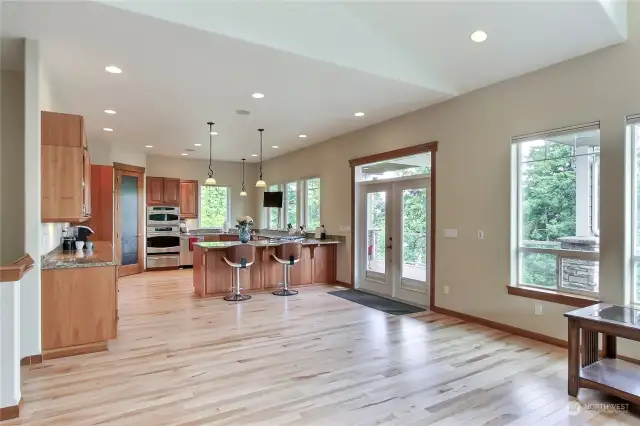 View from Great Room to your Chef's kitchen with patio doors leading to your length-of-house deck.