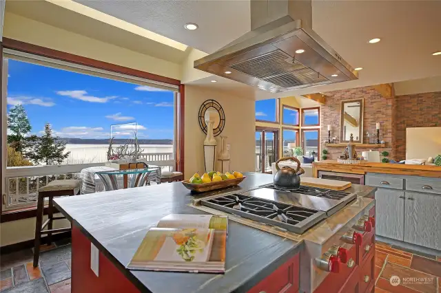 Soap stone Island with Wolf range, stainless hood, & room for a bistro table set.