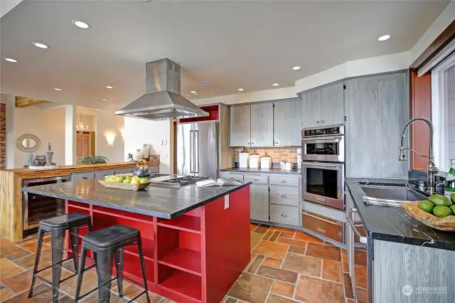 Custom cabinetry with built in cook book niches. The island makes a great place to visit with the Chef!