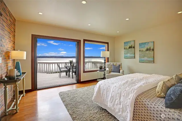 Primary Suite with French doors out to the deck. Beautiful hardwood floors.