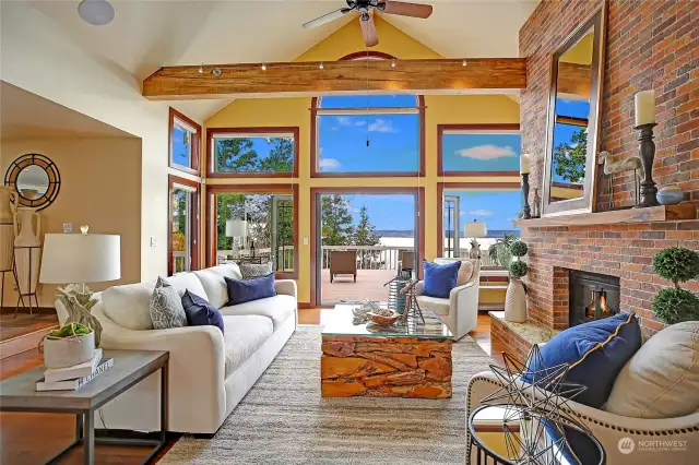 Great room concept with valuted ceilings, beams, beautiful hardwoods, french doors and large windows for natual light. Brick fireplace and hearth make this room nice and cozy!