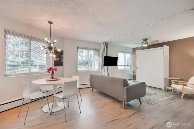 Living/dining area with open spaces. Double Murphy bed in cabinet with curtain that can be closed for privacy giving extra sleeping options.
