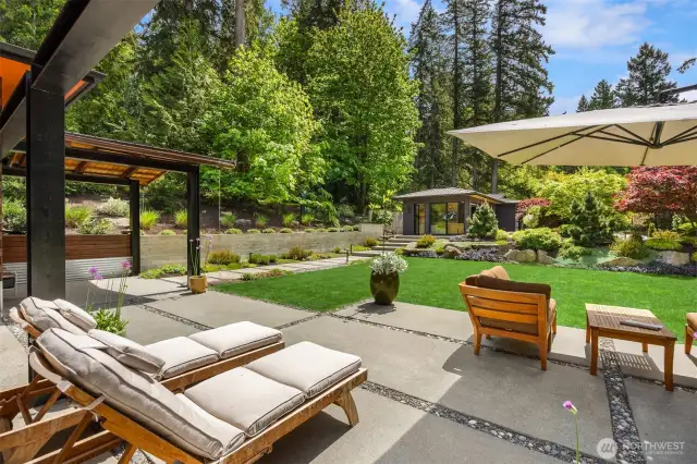 The sun soaked front patio is the perfect place to relax and take in the exquisite gardens.