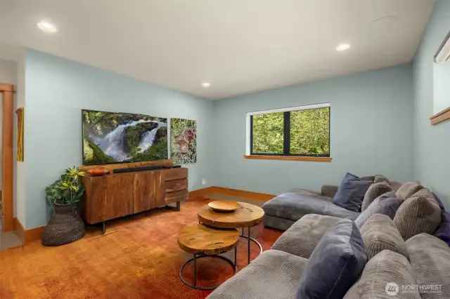 The family/media room is a great space to cozy up and watch a movie.