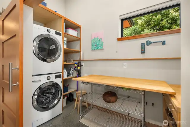 The laundry room is large with a folding table, but tucked away behind a large barn door.