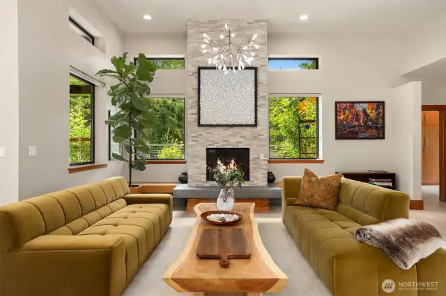 The living room with propane fireplace, designer lighting and west facing windows