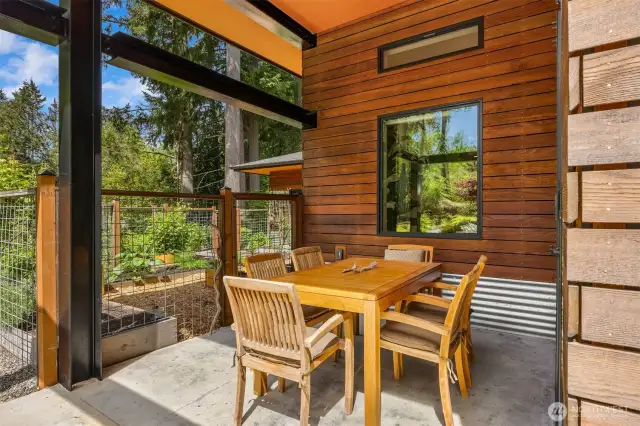 The outdoor dining area overlooking the garden spaces.