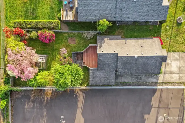 Basketball sports court adjacent to property. Aerial view showcases fenced lot and so much potential