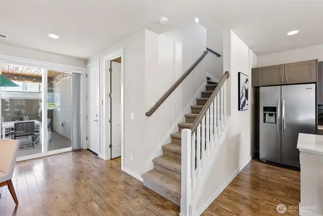 Attached garage door is tucked away from the kitchen, and downstairs features a powder room.