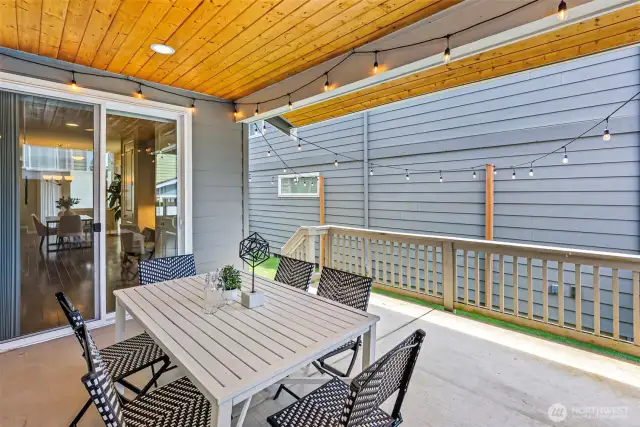 Sliding doors off the kitchen lead to a covered patio, perfect for year-round gatherings and outdoor dining.