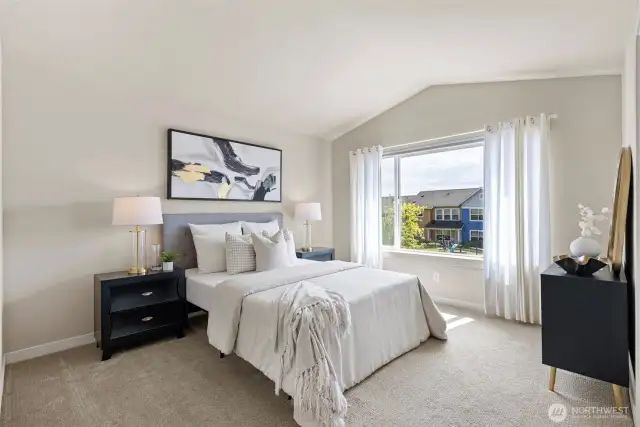 Primary bedroom features cathedral ceilings and a large walk-in closet.