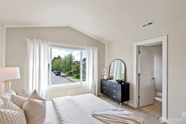 The primary bedroom is filled with natural light and features a private ensuite bathroom for added comfort and convenience.
