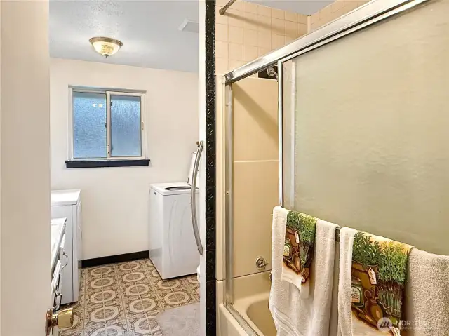 Full size bathroom with laundry.