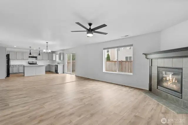 Modern ceiling fan in the Family room, open to Kitchen.