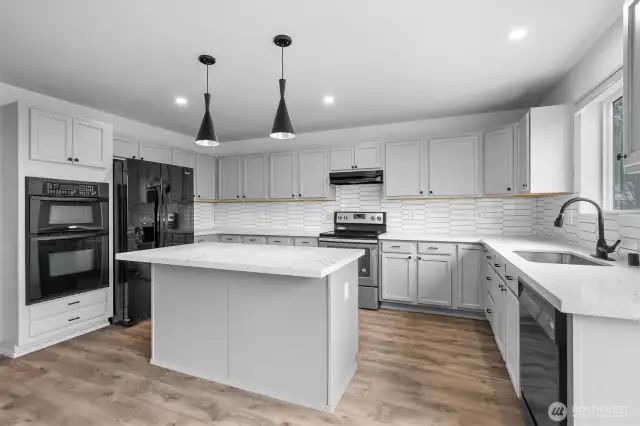 All appliances are included in the sale, including the double oven and large refrigerator.