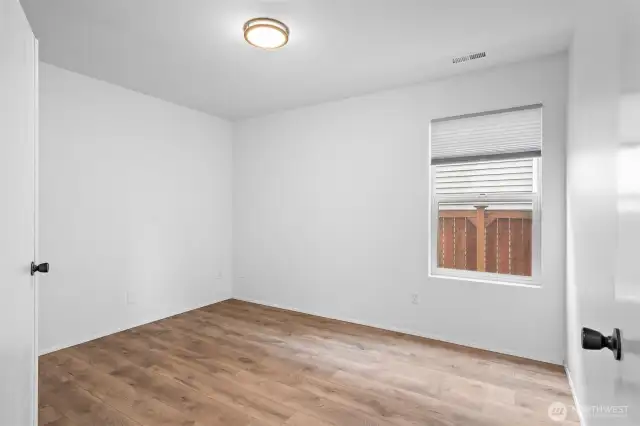 The laminate flooring continues into the main level office/den.