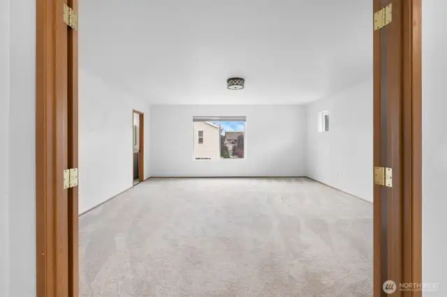 French doors open into the spacious Primary suite.