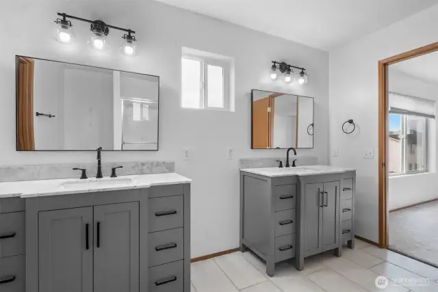 His and her vanities in private Primary bathroom.