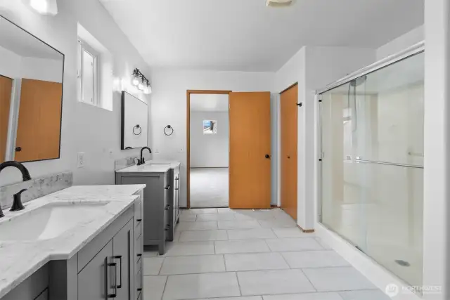 Walk-in shower with glass door.