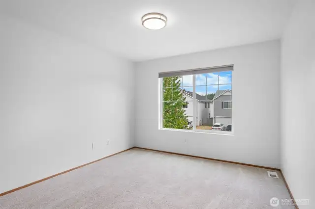 One of four guest bedrooms located on the upper level, three of which have walk-in closets.