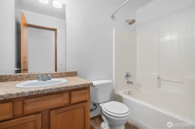 One of two guest bathrooms located on the upper level, each with a shower/tub combo.