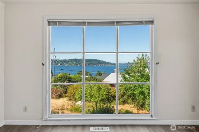 Welcome home—floor-to-ceiling windows in the living room frame Lake Washington in all its glory, offering an ever-changing panorama of natural beauty right from the moment you walk in.