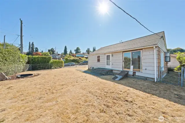 This spacious, fenced yard opens up to creative possibilities—garden, entertaining space, or your expansion ideas!