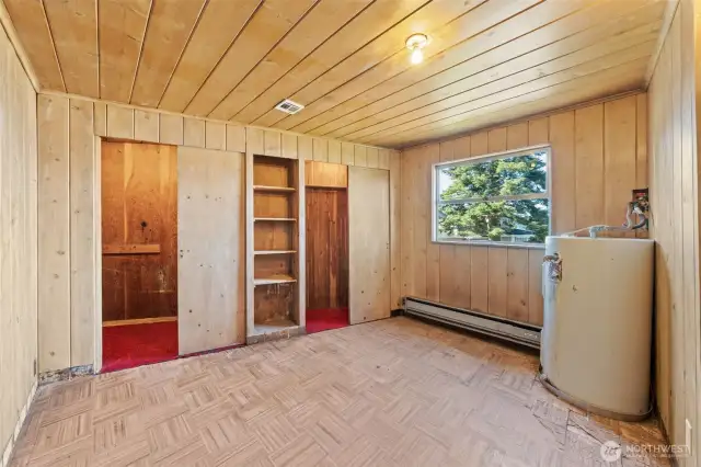 A versatile first bedroom with built-in shelving and storage, ready to be customized to suit your needs.