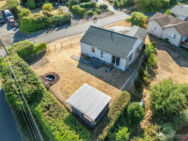 The expansive lot view showcases the fully-fenced open layout and charming gazebo, creating the perfect setting for gatherings.