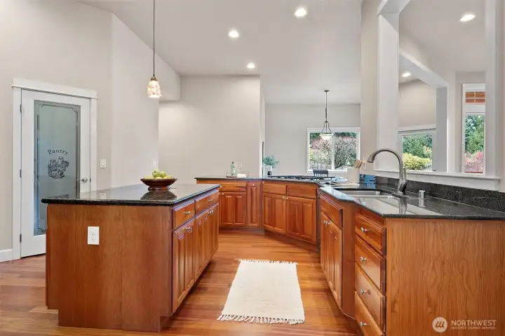 Step into this gourmet kitchen with plenty of storage space, working counter top space and room to cook a casual dinner or elaborate meal. The kitchen features modern appliances and ample natural light, making it a chef's dream.