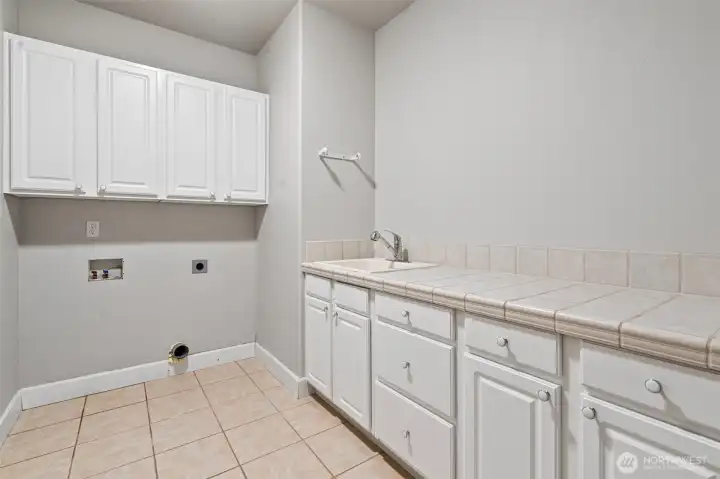 The laundry room is large with fantastic storage.