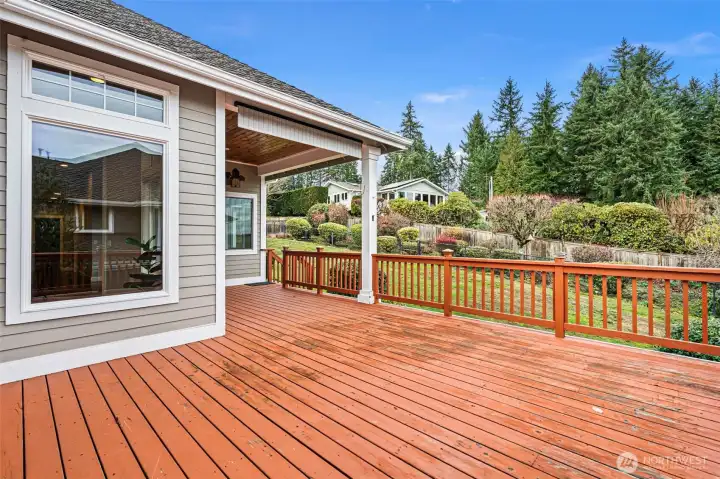 The large deck at the back of the house has covered and open areas.  Host an outdoor dinner with a view of Puget Sound.  The yard is fully fenced, with an added enclosed dog-run area.