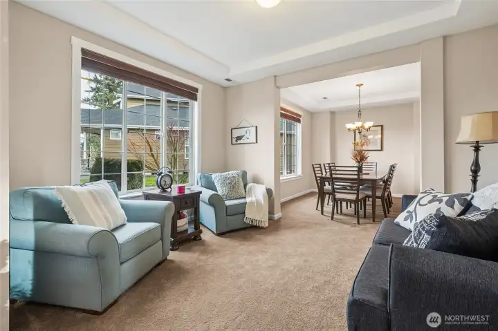 Just off the entry the formal living room offers a refined space for quiet conversation or welcoming guests. Large windows bring in natural light.