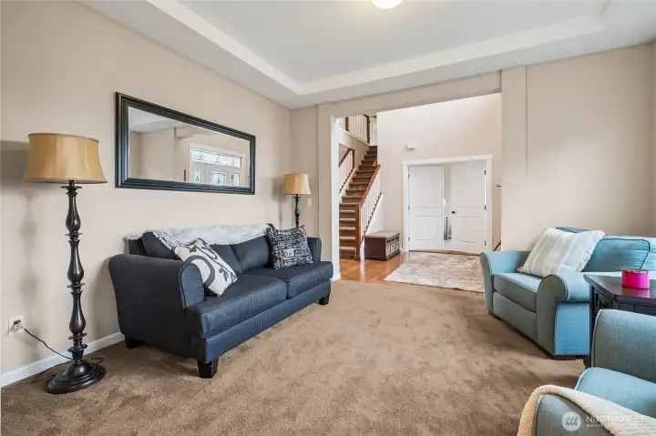 The formal living room provides flexible use as a reading room, music room, or additional entertaining space. Its separation from the main living area allows for quiet enjoyment and added functionality.