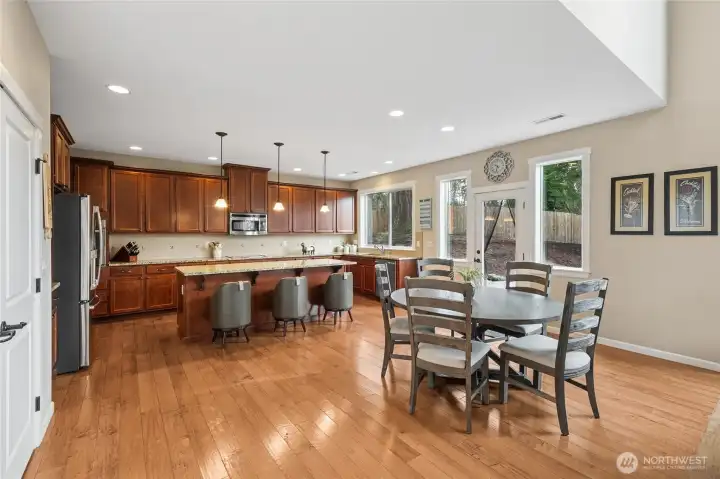 The bright breakfast nook overlooks the backyard, offering a peaceful place to start the day. Natural light fills the space beautifully.