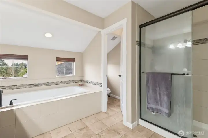 The five-piece ensuite bath offers a spa-like retreat with a luxurious garden tub perfect for relaxing at the end of the day. A separate water closet adds privacy, while the well-appointed layout provides both comfort and functionality.