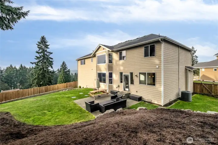 The generous half-acre lot offers space to relax and entertain, with room to garden or play. A rare find in this desirable community.