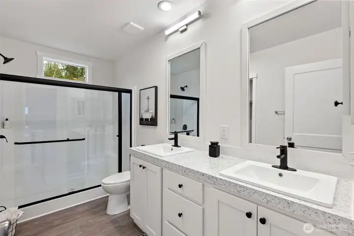 Master Bath with Double Vanity and Walk in Shower and Closet.