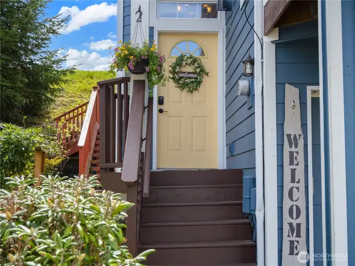 Sunshine colored front door welcomes you in.