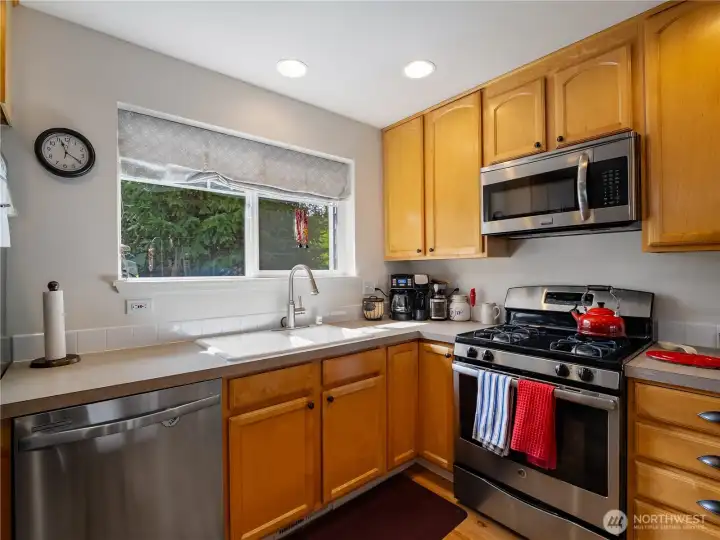 Gas stove and a sink with a view; what more can you ask?