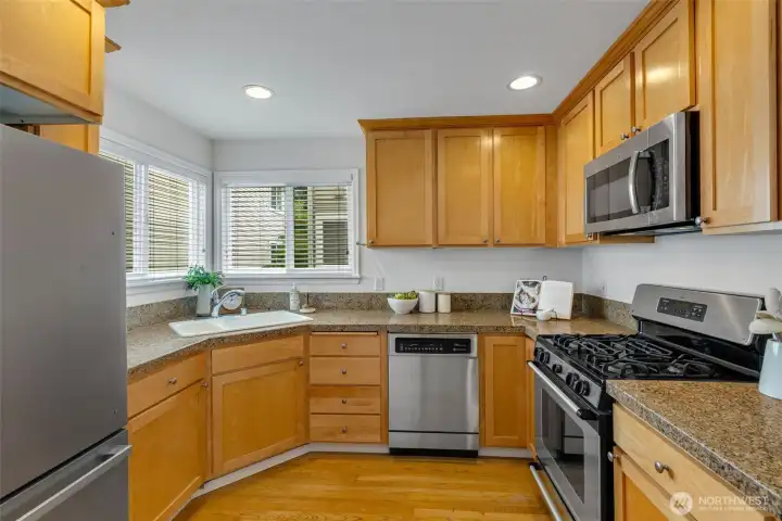 Open light filled kitchen with SS appliances.