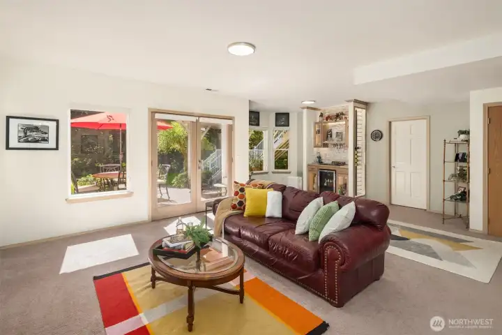 Family Room on the Lower level, with fireplace, bar area, access to back patio~