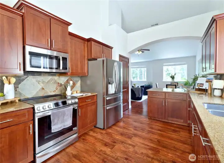 Kitchen with granite counters, stainless appliances and eating bar.