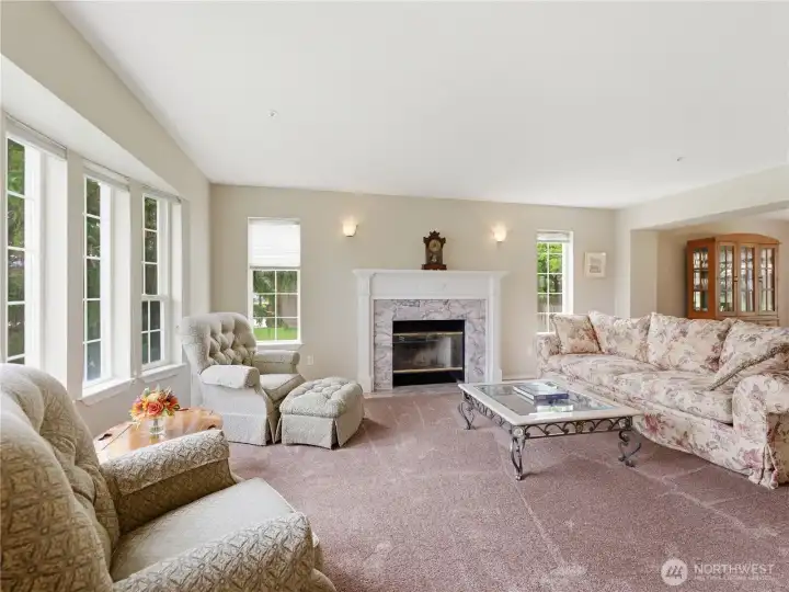 Expansive living room featuring a stunning wood-burning fireplace and abundant natural light.