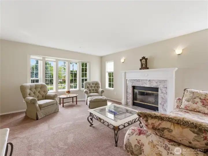 Large living room ideal for entertaining guests or relaxing around the wood-burning fireplace.