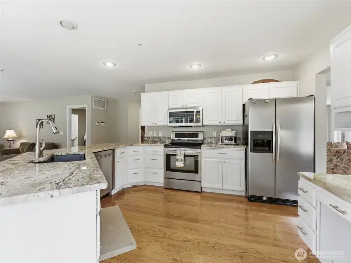 Beautiful kitchen featuring granite countertops and abundant workspace for meal preparation.