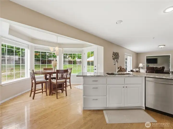 Bright dining nook overlooking the backyard and outdoor entertaining spaces.